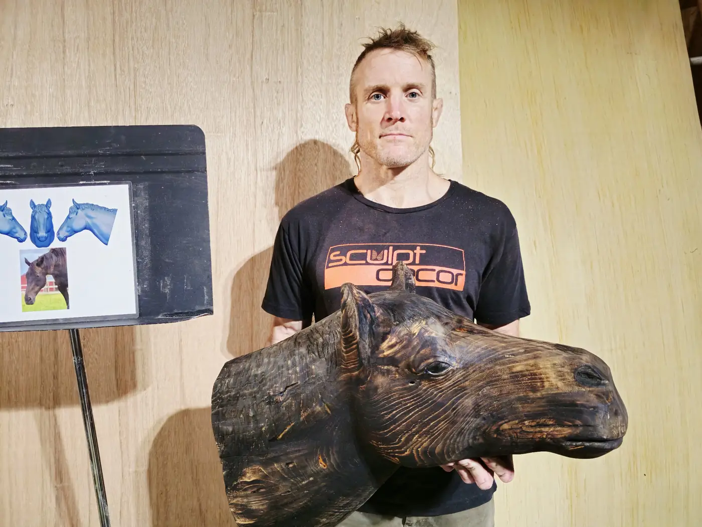 Master sculptor Dustin Weatherby working alongside a clay piece