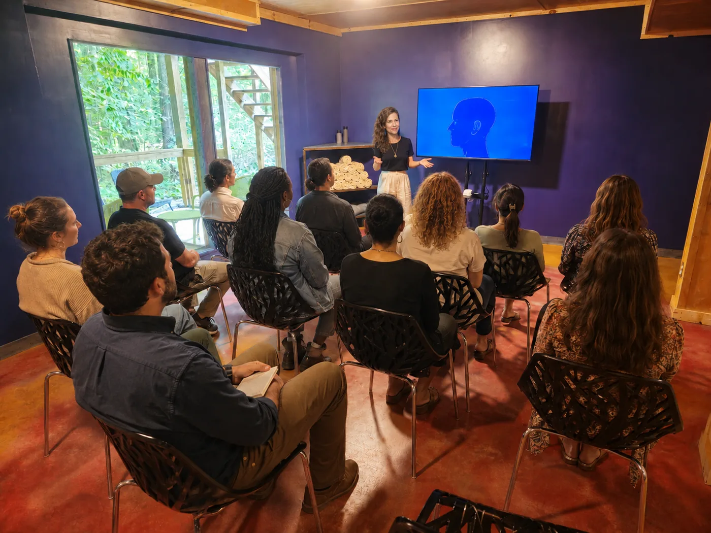 Raven Morgan leading a wellness coaching session for a seated group at Raven’s Retreat Hocking Hills