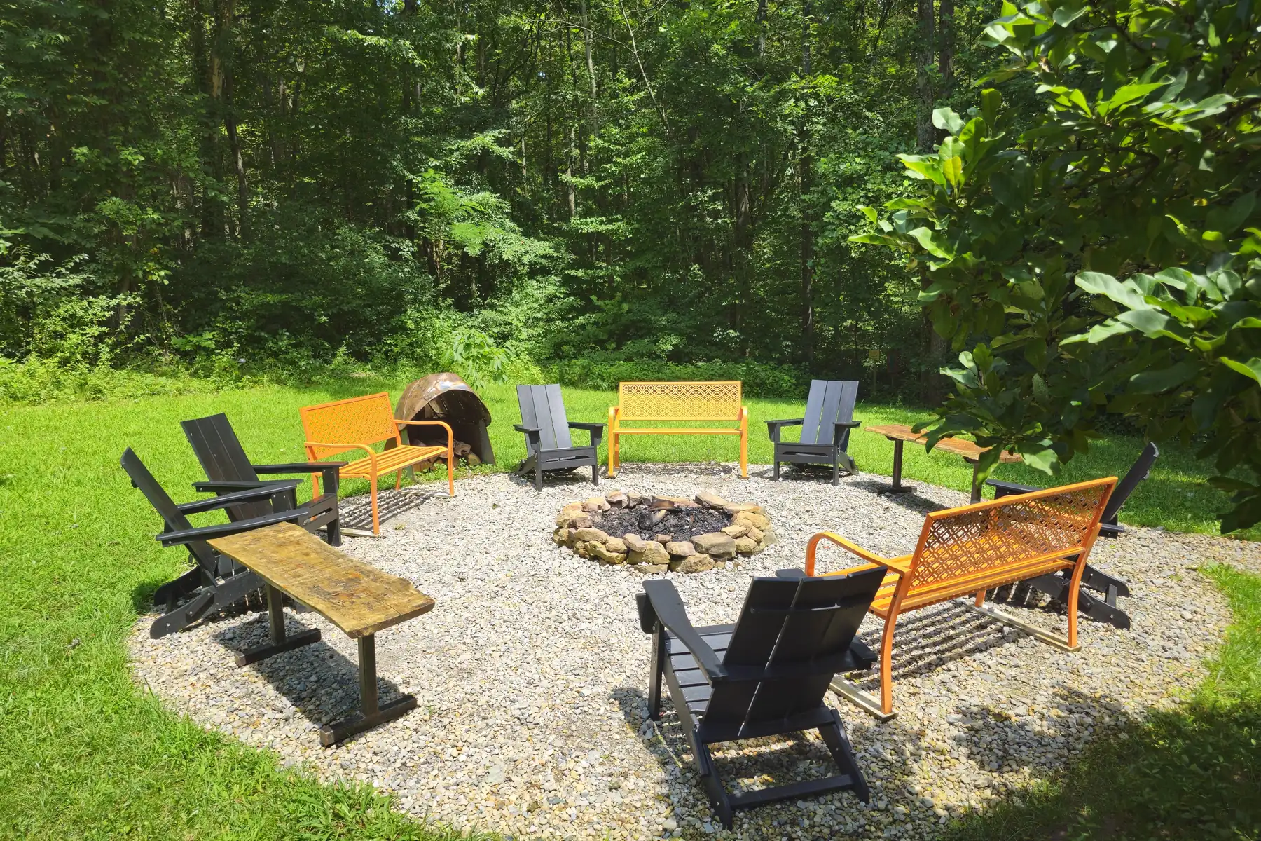 The firepit ring and benches beside the pond at Raven’s Retreat Hocking Hills