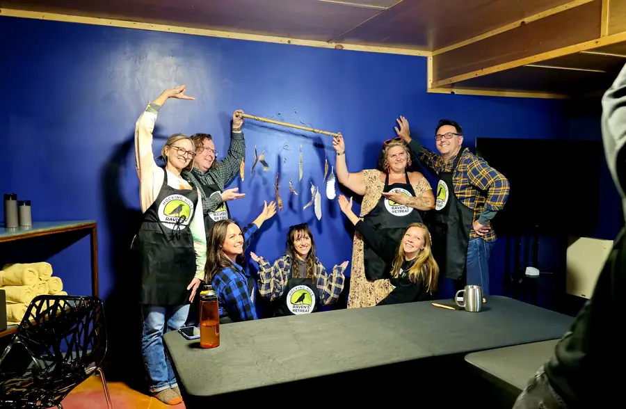 A team celebrating together after a group workshop in the Art Lodge at Raven's Retreat Hocking Hills