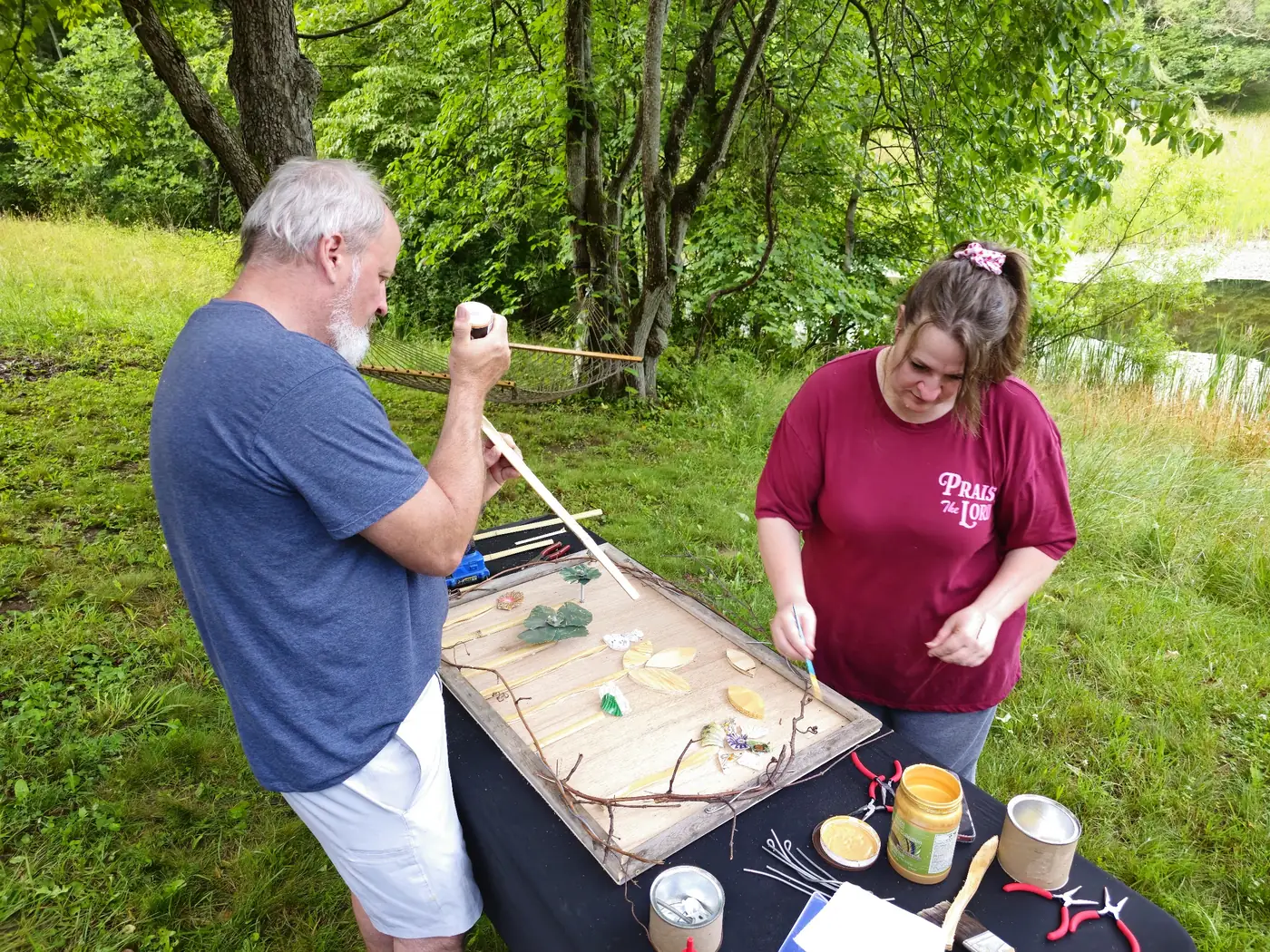 Couple working together at a sculpture workshop during a reconnection retreat