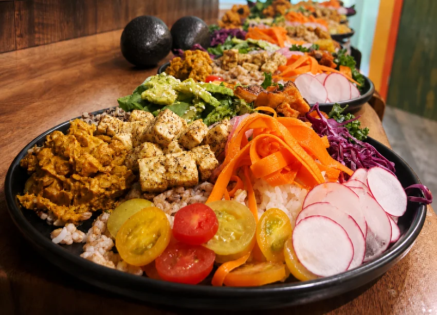A plant-based grain bowl with tofu and avocado served during a team retreat
