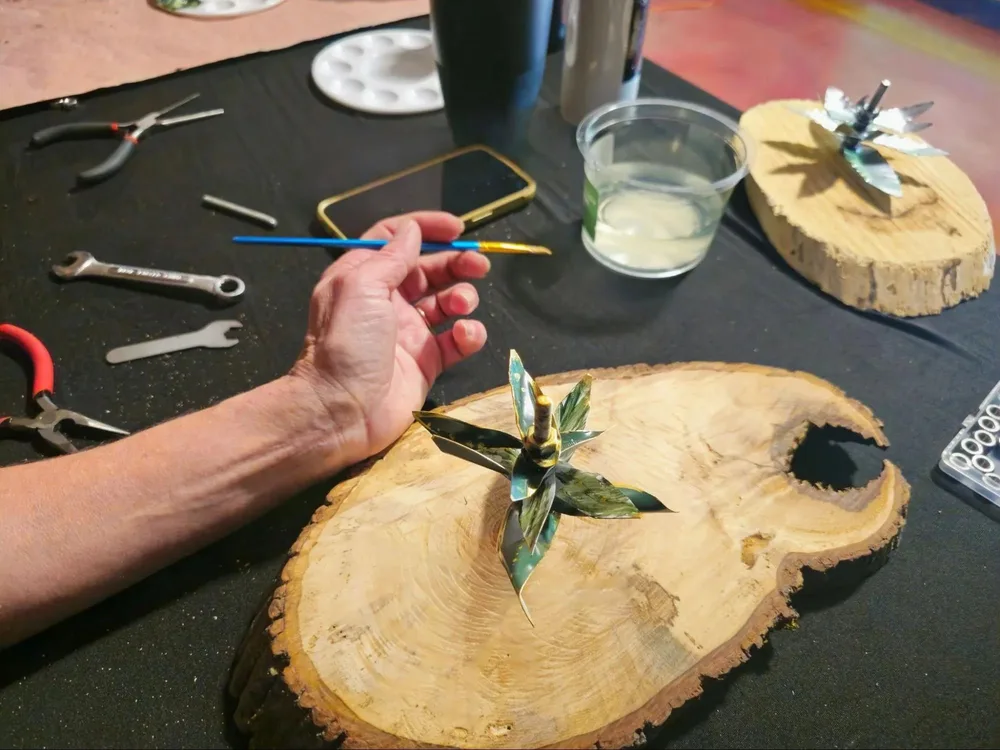 Hands assembling natural materials during the sculpture session
