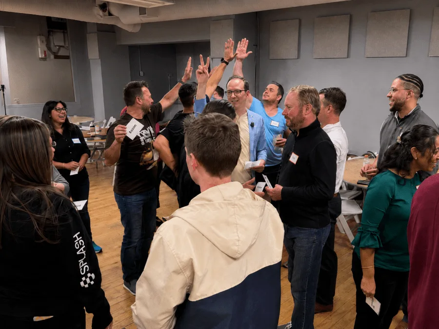 A corporate team celebrating during an improv team building workshop with WitWorks