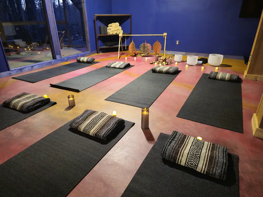 A group gathered for a sound bath in the Art Lodge during a team retreat