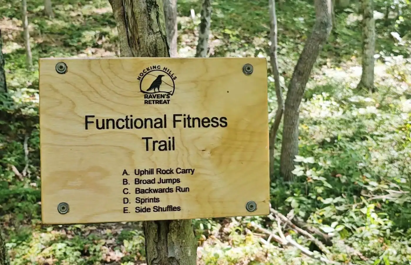 The signed functional fitness trail running through the forest at Raven's Retreat