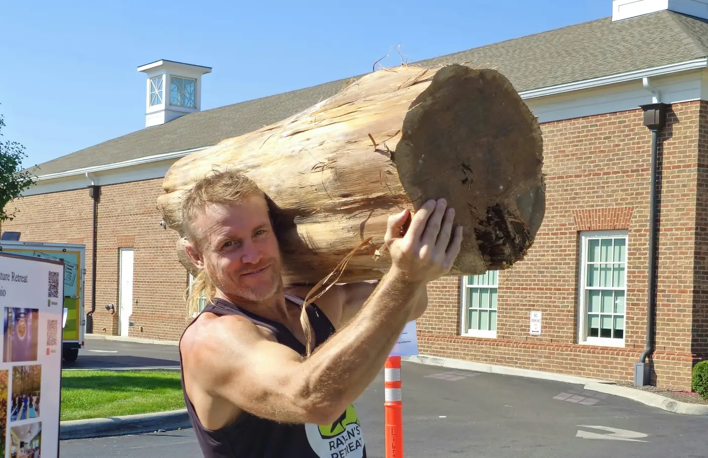 Dustin Weatherby working a finished wood sculpture in front of an audience