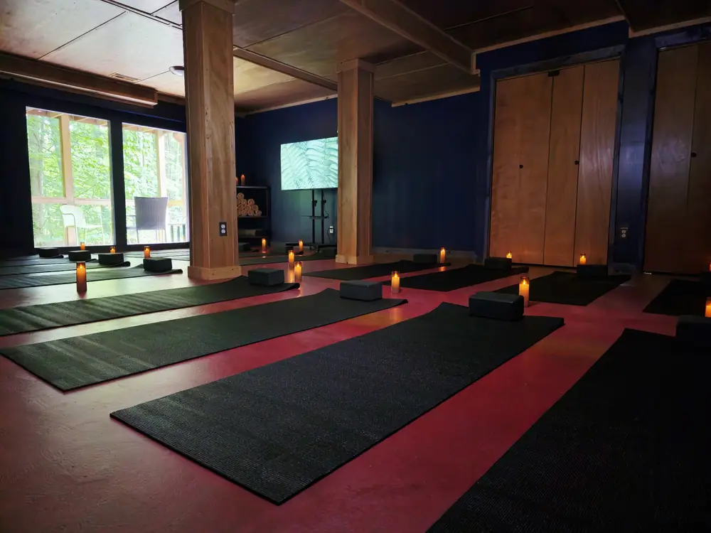 The indoor yoga shala at the Art Lodge, laid out with mats