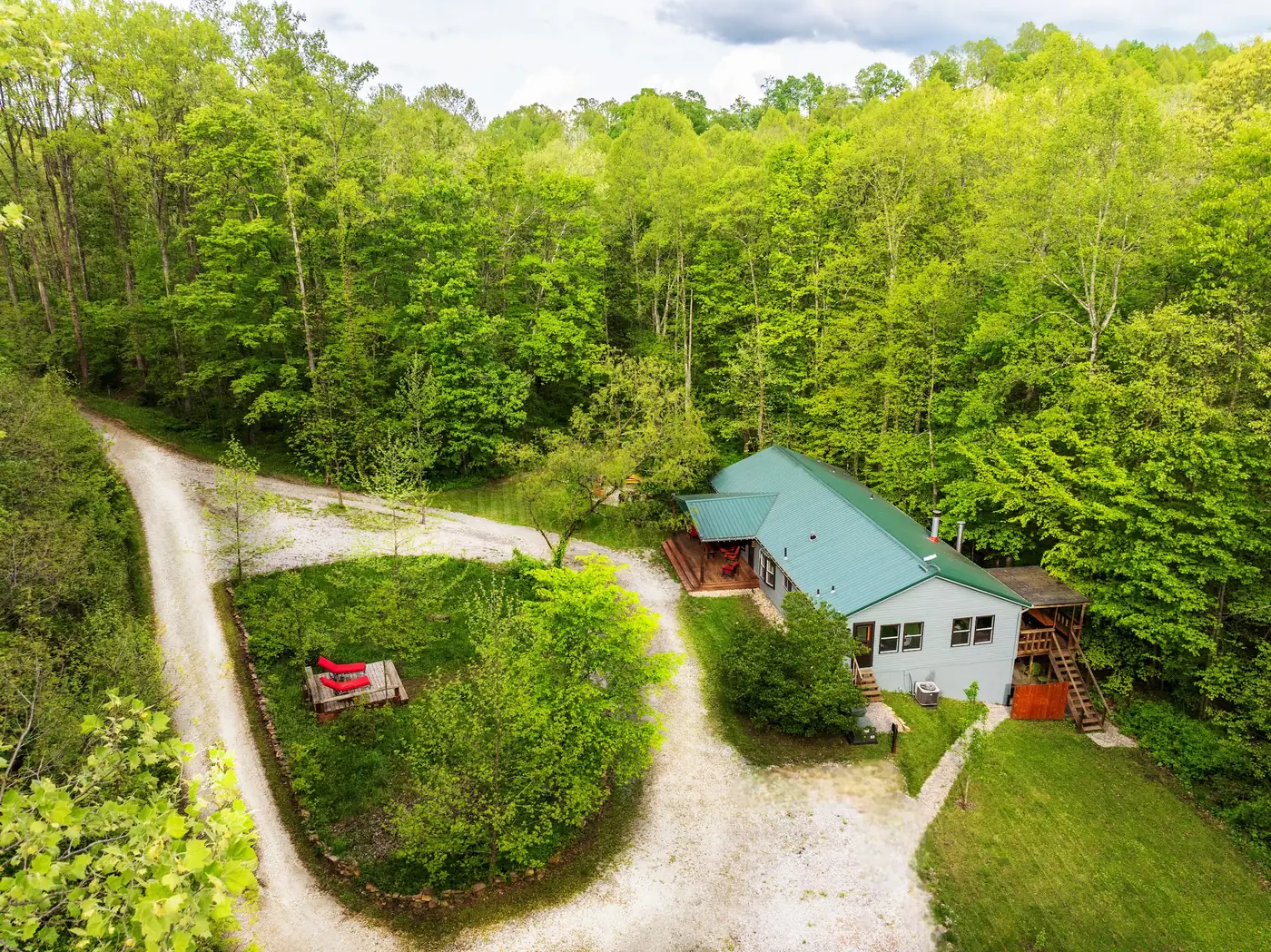 Aerial view of the Sculptor's Art Lodge and its drive, surrounded by the wooded 58-acre preserve at Raven's Retreat Hocking Hills