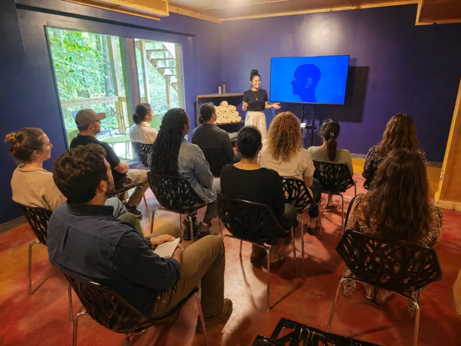 A corporate forum group seated for a facilitated session in the Art Lodge
