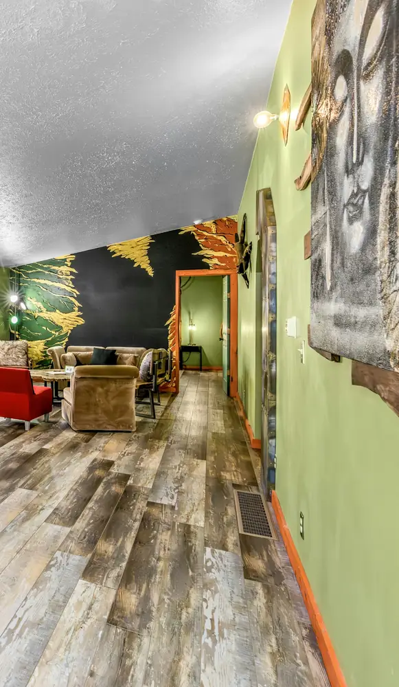 Living room with hand painted mural by Raven Morgan within Art Lodge at Raven’s Retreat Hocking Hills