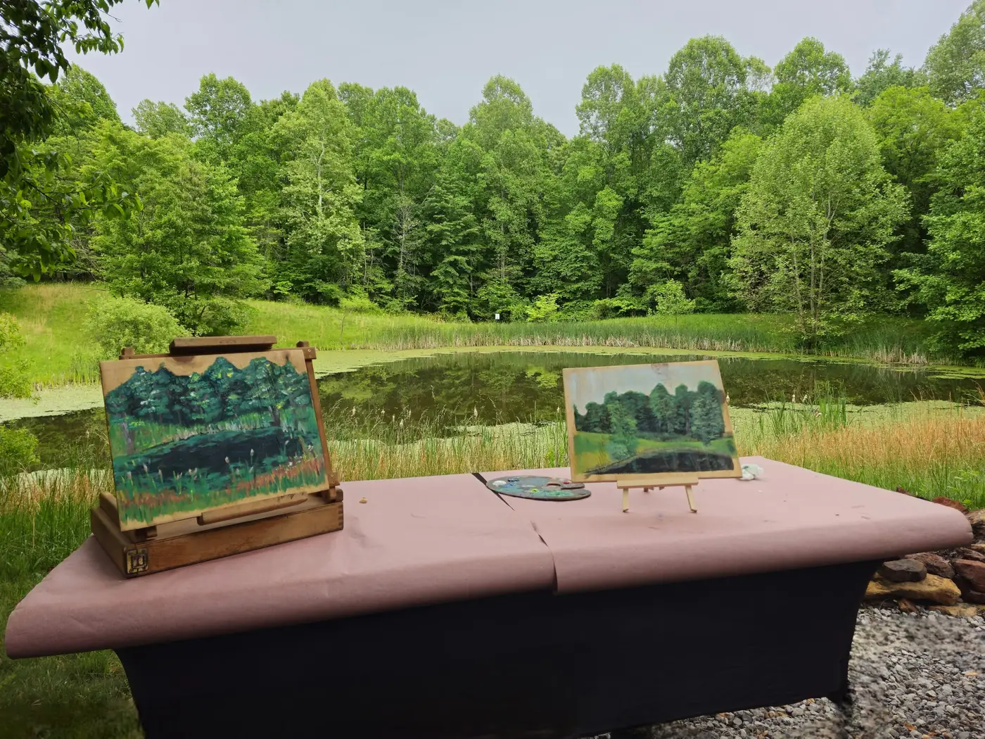 Finished paintings on easels beside the pond after an outdoor creative session at Raven's Retreat Hocking Hills
