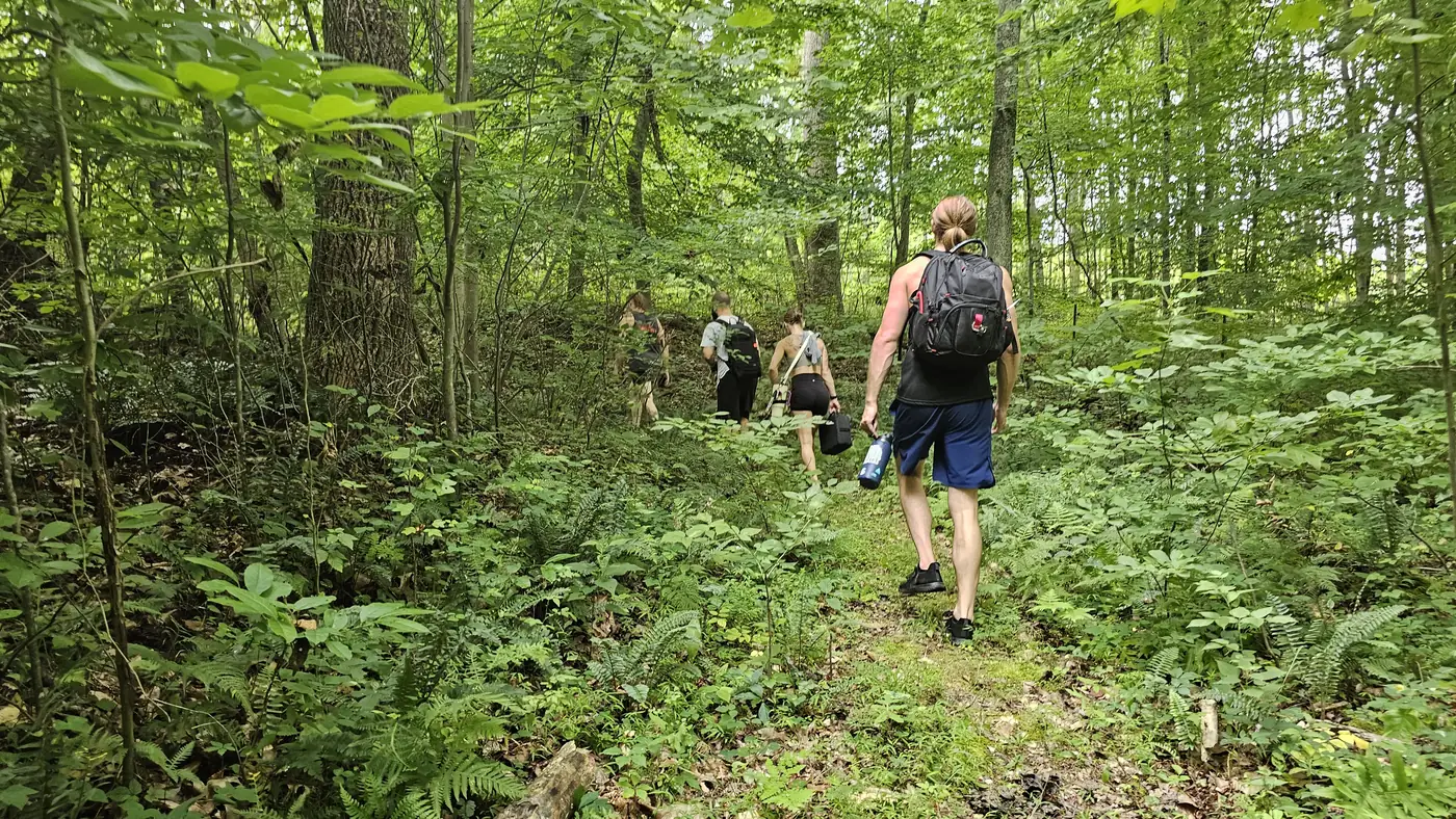 Guests hiking the private wellness trail through the 58-acre preserve