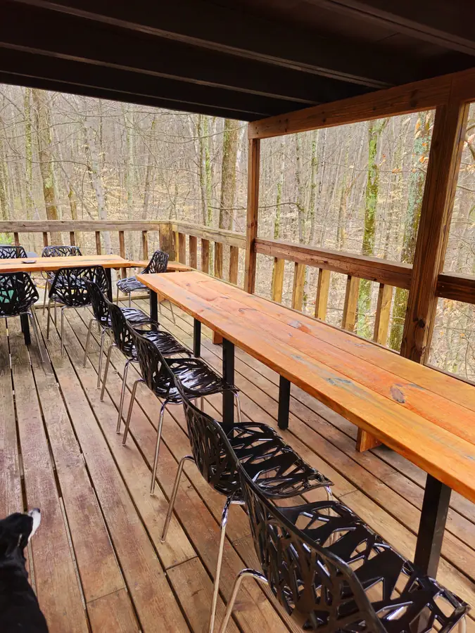 The long outdoor dining table on the Art Lodge balcony, set for a group retreat