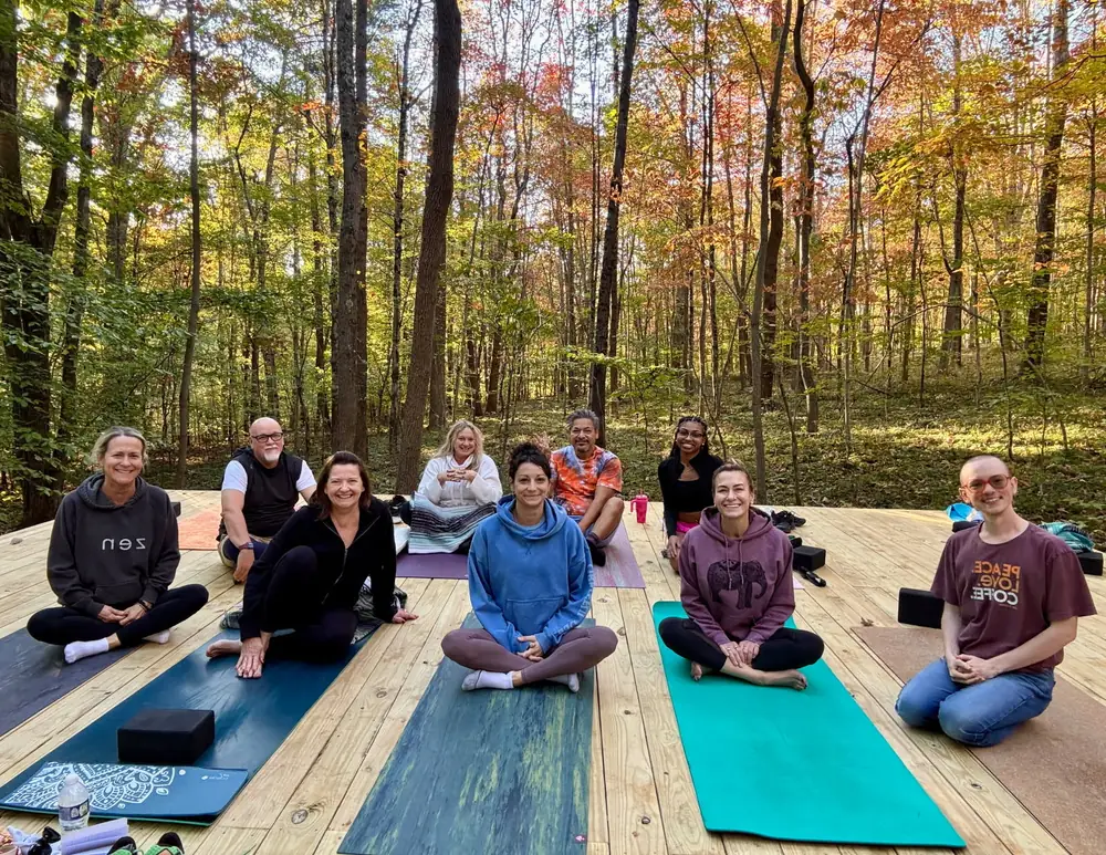 Yoga for group wellness retreat on forest platform at Raven’s Retreat Hocking Hills