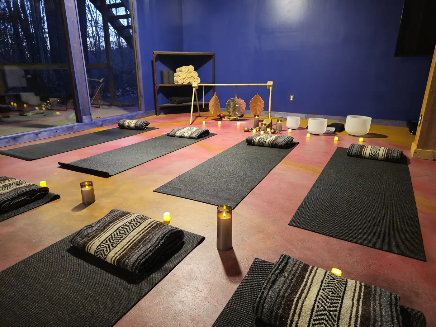 Group sound bath laid out with mats and bowls inside the Art Lodge