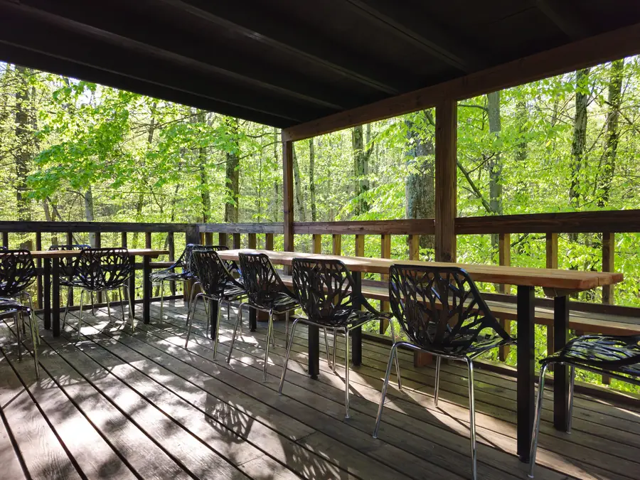 Covered balcony seating at the Art Lodge, set up for a group day retreat