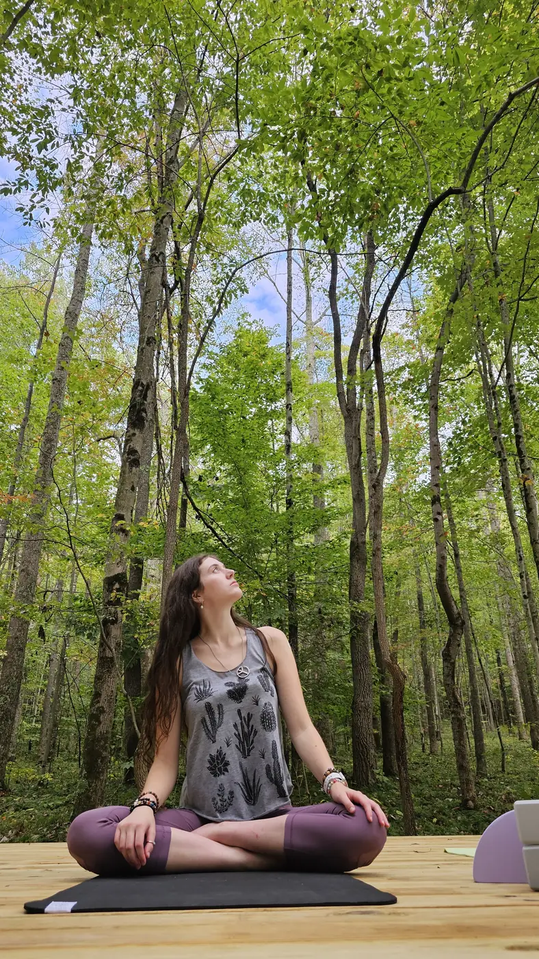 Guest meditating on the elevated forest platform at Raven's Retreat Hocking Hills